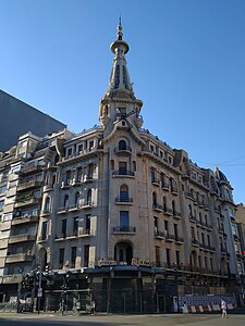 Confitería del Molino by Francesco Gianotti in Buenos Aires (1916). 5 floors building on a corner with pointy dome covered in stained glass "petals" with a windmill at the centre.