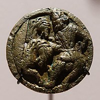 Medallion with man in Central Asian costume attending two horses, Takht-i Sangin, 2nd century BC-2nd century AD. The costume is said to be "Scythian".[28]
