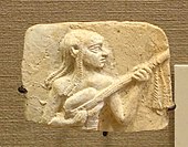 Iraq. Musician playing a lute, Tell Ishchali, Isin-Larsa period, 2000-1600 BC, baked clay. Hanging tassels are part of harness to hold strings, one for each string.