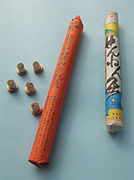 Stick–on moxa (left) and moxa rolls (right) used for indirect moxa heat treatment. The stick-on moxa is a modern product sold in Japan, Korea, and China. Usually the base is self-adhesive to the treatment point.