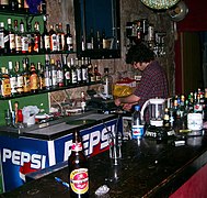 A bartender at work in a pub in Jerusalem