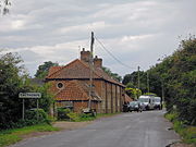 The approach to the village from Erpingham where the lane crosses Scarrow Beck.