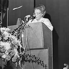 Väänänen speaking on a podium.