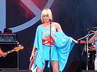Robyn onstage in an off-the-shoulder blue outfit