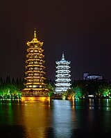 The Sun and Moon Pagodas lighted at night and reflected in Lake Shanhu in November 2017.