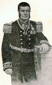 Engraved, three-quarters-length portrait of a man with dark hair and sideburns leaning against a plinth and dressed in an elaborately embroidered naval uniform with a double-breasted tunic adorned with epaulettes and medals