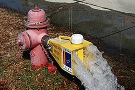 A fire hydrant flushing water through a diffuser in Durham, North Carolina