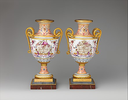 Pair of amphora-shaped vases decorated with festoons, rinceaux, trophies (one made of musical instruments and the other made of scientific ones), and sphinxes