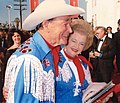 Roy Rogers in fringed Western shirt and Dale Evans in matching fringe jacket