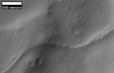 Image from previous photo of a curved ridge that may be an old stream that has become inverted. Illumination is from the NW. Image taken with HiRISE under the HiWish program.