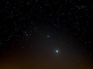 The bright Venus in the cone of the zodiacal light 8 degrees above the western horizon on 23 March 2020. This was eleven days before Venus approached the Golden Gate of the Ecliptic (centre) between the Pleiades (right) and the Hyades together with Aldebaran (left) in the constellation Taurus (centre).
