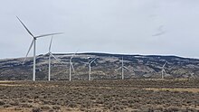 Wind turbines in the foreground with the Pryor Mountains in the background.