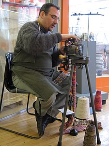 A similar old sock-knitting machine in use