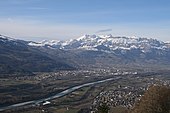 Blick von Triesenberg talwärts auf rechts die Gemeinde Schaan in Liechtenstein über den Alpenrhein hinüber auf die Gemeinden Buchs SG, Grabs und Gams SG auf die noch schneebedeckten Berge des Alpsteines.