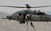 Soldiers from the 19th Group "Fast Roping" from an Air Force HH-60 Pave Hawk helicopter at the Utah Test and Training Range in November 2007, during CSAR integration exercises.