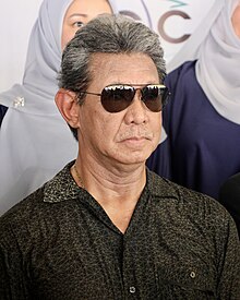 Jefri Bolkiah 2023. Porträt eines grauhaarigen Malayen mit Sonnenbrille.