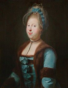 Left-looking portrait of a woman wearing a blue dress, trimmed with fur