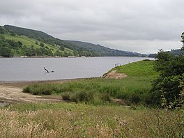 Image of a lake with steep hills beyond