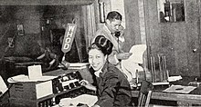 Photograph of an African-American woman and man in a 1950s style radio station