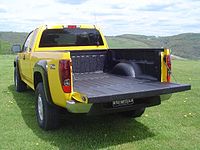Chevrolet Colorado flat-sided pickup truck showing wheel well intrusion into bed