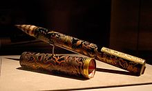 Brush with a filling pen of a specific shape and size, adorned with golden and silver dragons on a black background