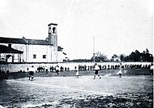A black and white photo of a football pitch during a match
