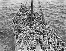 Black and white photograph of a group of soldiers on a boat