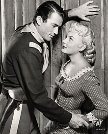 A black and white photograph of Peck with Barbara Payton in Only the Valiant.