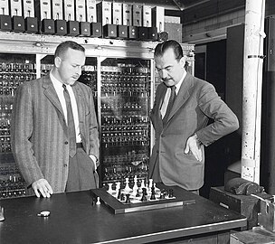 Paul Stein and Nicholas Metropolis play Los Alamos chess against the MANIAC, a simplified version of the game without bishops. The computer still needed about 20 minutes between moves.