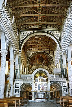 San Miniato al Monte, Florence, has basilical form, open timber roof and decoration of polychrome marble and mosaic.