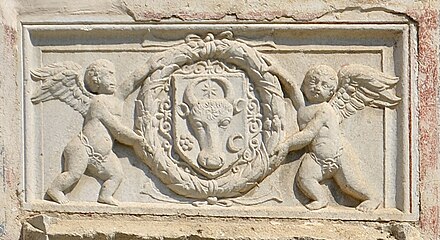 Relief with the coat of arms of Moldavia in a laurel wreath hold by two cherubs (aka putti), above the pisanie of the Saint Demetrius of Thessaloniki Church, Suceava, unknown sculptor, 1534[11]
