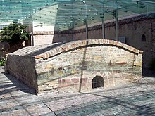 A photo of a rectangular stone building