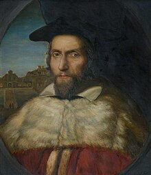 A portrait of a middle-aged, bearded man in academic robes and cap.