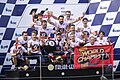 Marc Márquez, celebrating with his team on the podium after winning his sixth MotoGP world championship title and the 2019 Thailand motorcycle Grand Prix