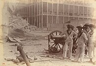 British sailors pose with a captured cannon outside the sultan's palace