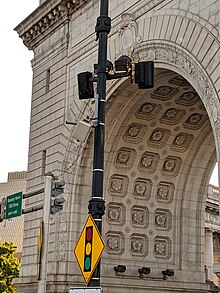 multiple electronic devices mounted on lightpole by the Manhattan Bridge