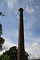 The 120-foot (37 m) tall chimney, brick with oversailing caps