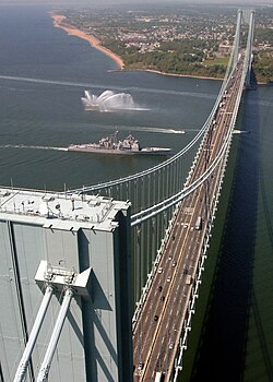 The Verrazzano-Narrows Bridge, shown with USS Leyte Gulf passing underneath it, spans The Narrows