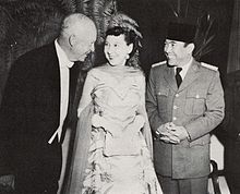Dwight, Mamie, and Indonesian President Sukarno dressed in formal wear smiling at one another