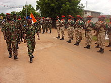 New Forces general Bakayoko reviews his troops who are standing at attention in regularized uniforms