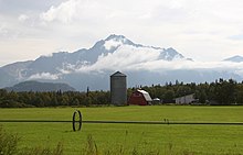 Agricultural farm in Alaska in the Matanuska Valley near the town of Palmer. The prominent mountain in the background is Pioneer Peak.