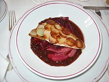 A potato and vegetable dish prepared with beurre rouge (red butter)