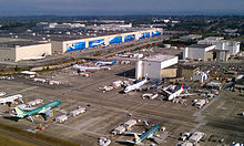Boeing's factory in Everett, Washington in 2011. The planes are on the tarmac outside warehouse-like buildings