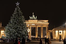 Christmas tree and menorah with Brandenburg Gate in background