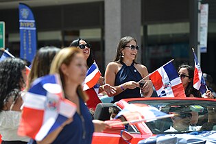 Dominicans in New York Dominican parade holding flags