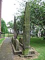 Image 48'Giants Grave', St. Andrew's churchyard, Penrith, an unusual arrangement of two Viking-age cross-shafts with four hogbacks (in the foreground). In addition, there is a smaller, Viking-age, wheel-headed cross just visible in the background (from History of Cumbria)
