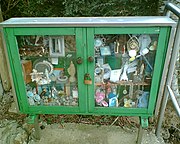 A cabinet containing offerings from pilgrims to a well