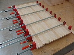 Bar clamps used to glue up a desk top