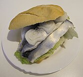 A Fischbrötchen made with pickled herring and onion