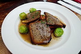Sliced nut roast with brussels sprouts